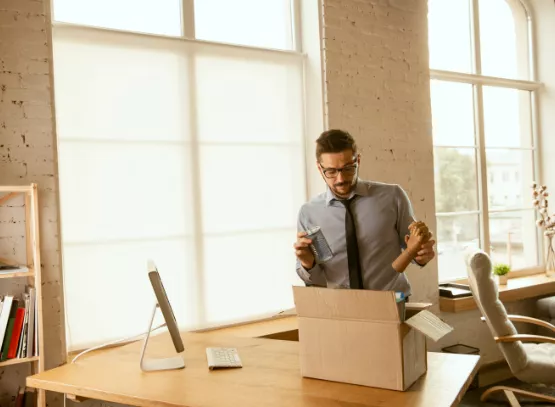 men packing stuff from office